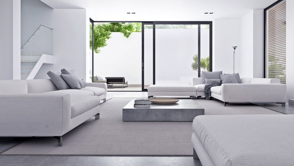 A modern living room featuring a low-profile, gray minimalist furniture sofa with clean lines