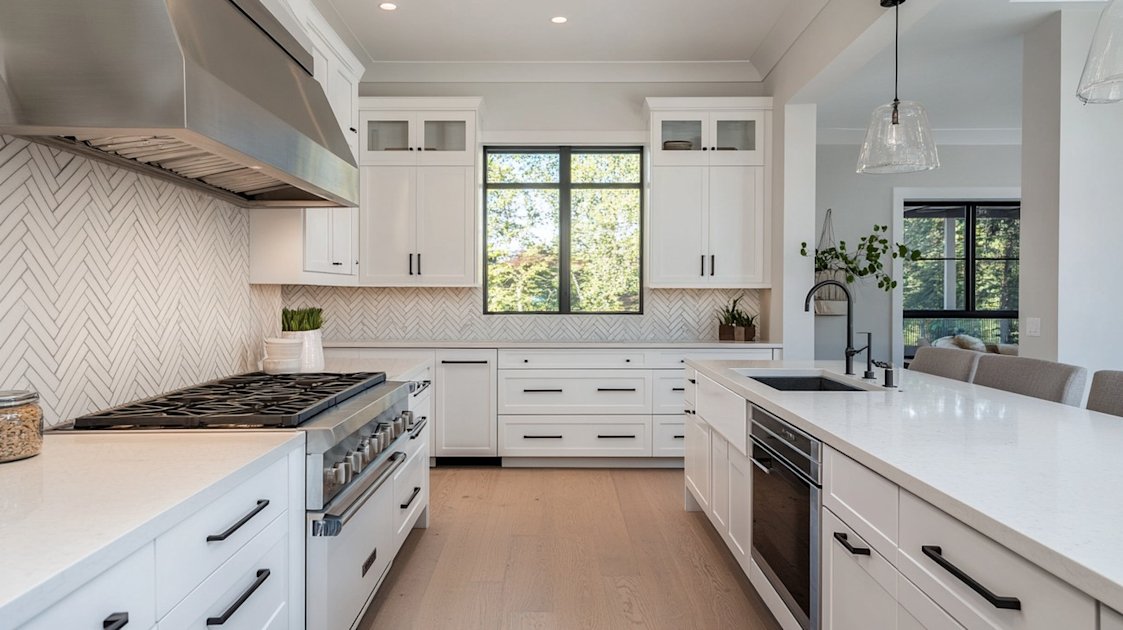Herringbone tile pattern backsplash in white kitchen