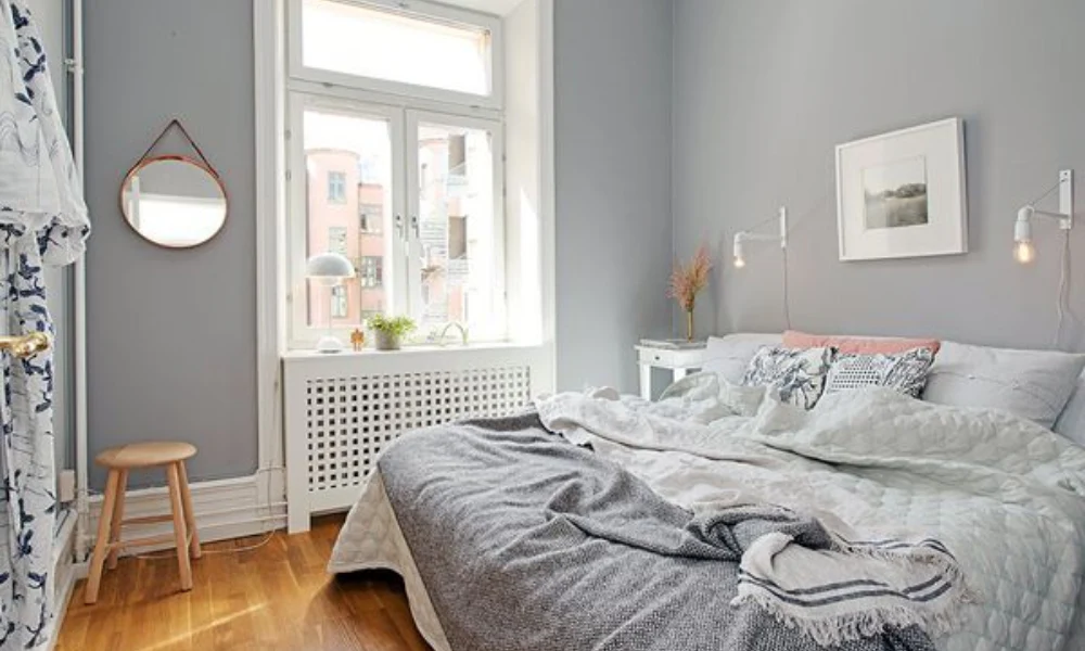 A small room painted in light gray tones with bright furniture and decor.