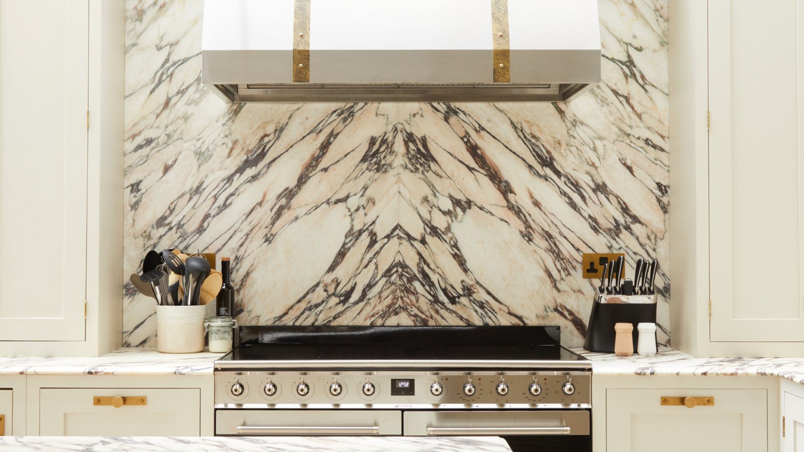 Luxurious marble kitchen backsplash with brass fixtures
