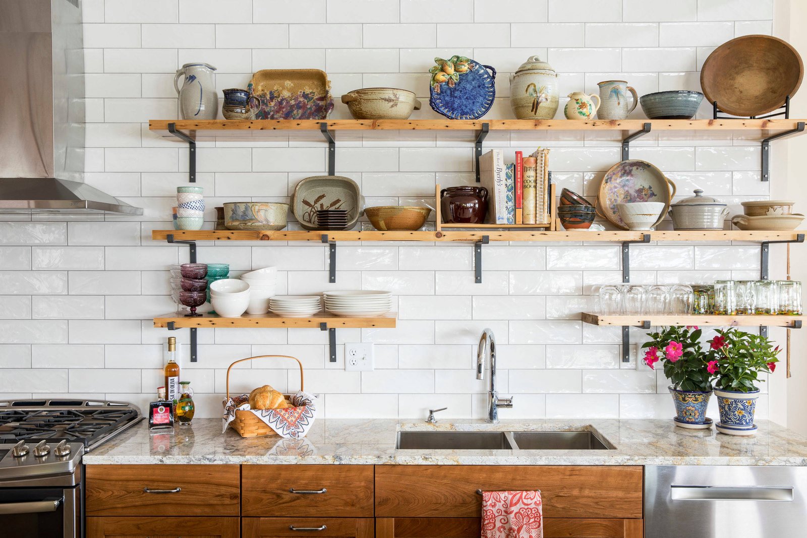 Open shelving in a small kitchen, displaying decorative items and kitchen essentials.