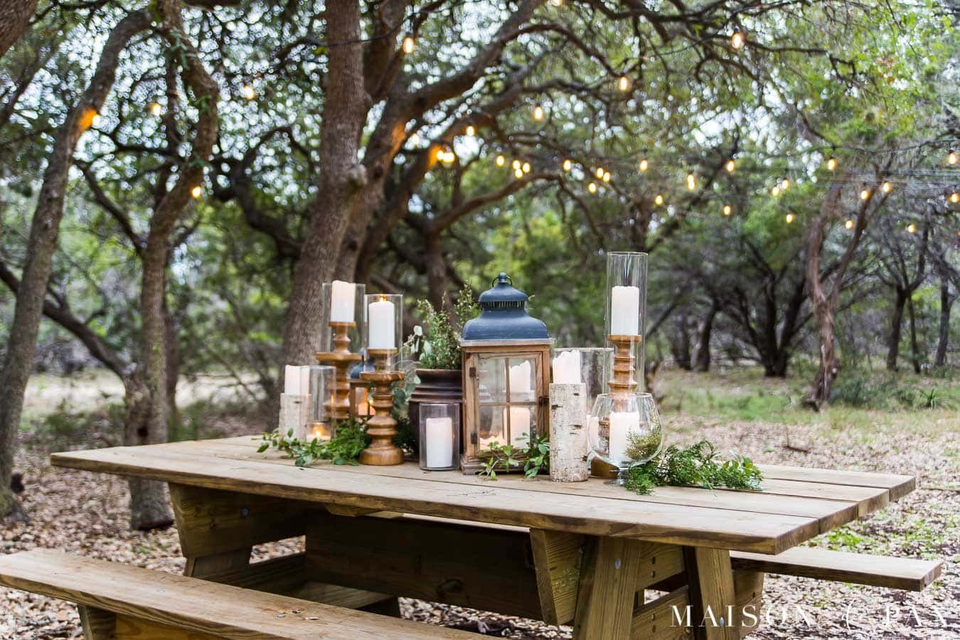 Outdoor dining furniture ideas with wooden tables, benches, and string lights