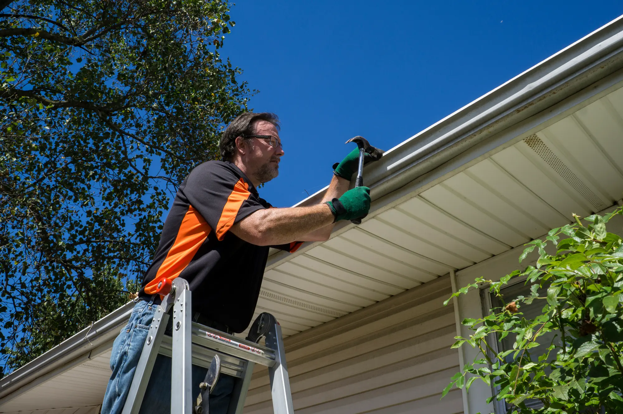 Preventive DIY home repair maintenance like cleaning gutters and sealing caulk