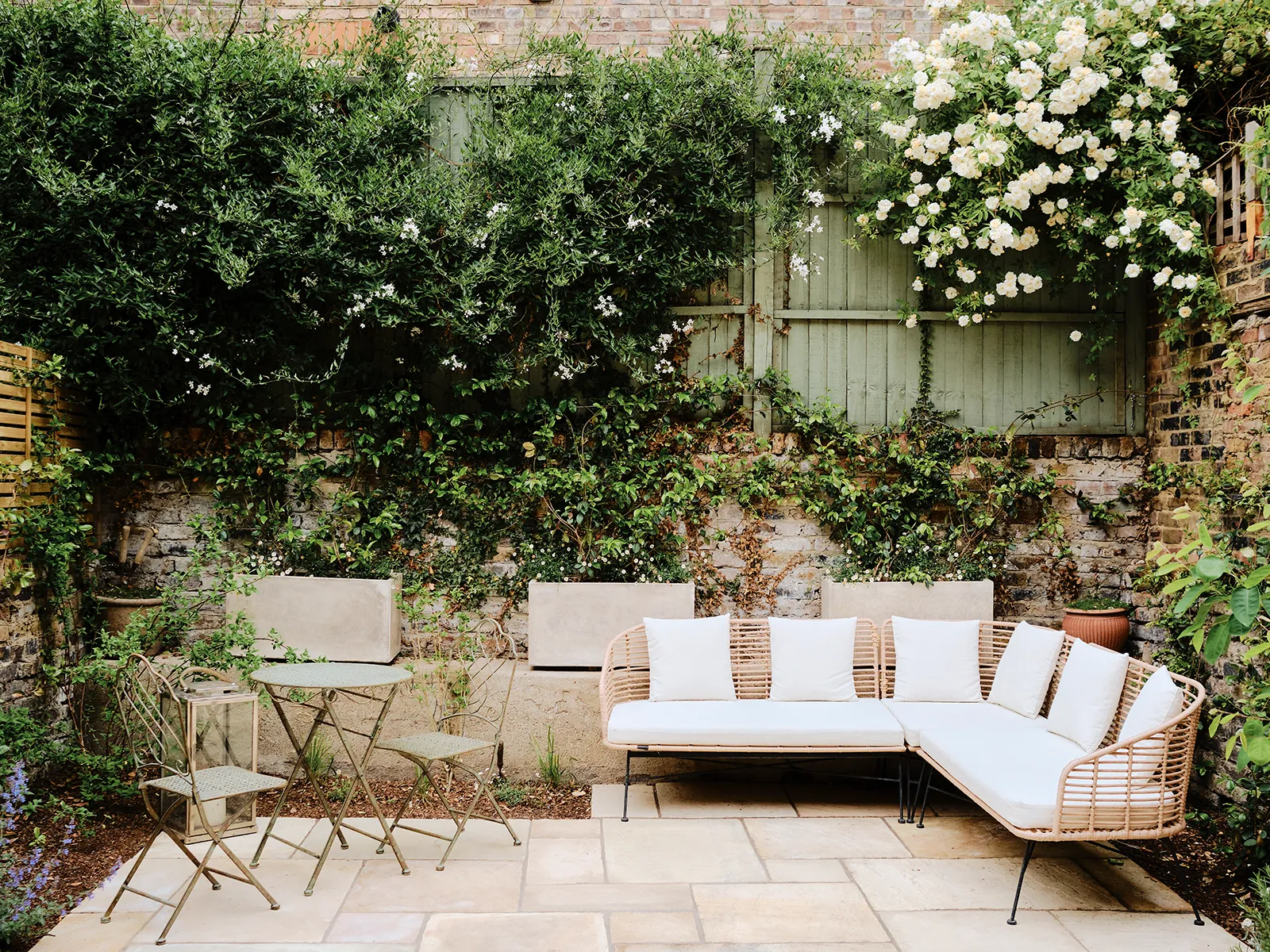 Small outdoor patio design with compact furniture and hanging plants