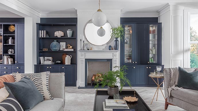 A small, modern living room with functional furniture and creative storage solutions.