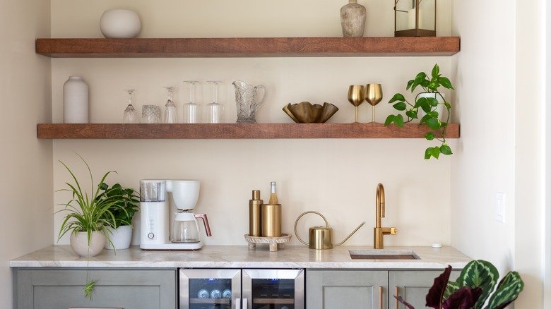 Vertical storage shelves in small kitchen design using wall space