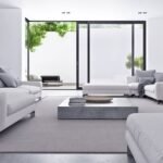 A modern living room featuring a low-profile, gray minimalist furniture sofa with clean lines